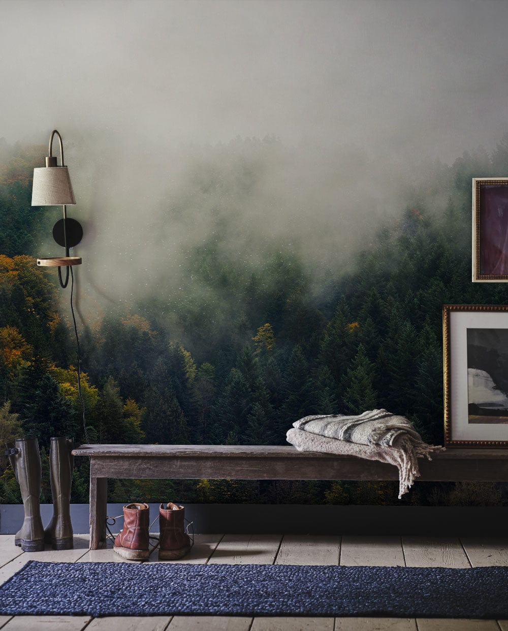 Misty Forest Green Scenic Mural Wallpaper in rustic room with wooden bench, mounted lamp, ceramic floor.