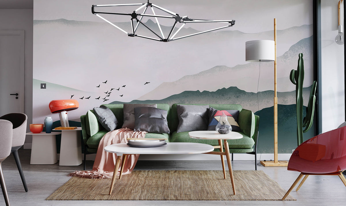 Green sofa, modern light fixture, serene misty mountains mural wallpaper; wooden flooring, contemporary living room.