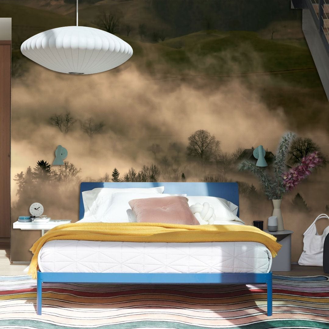 Tranquil Misty Woodland Mural Wallpaper, earthy tones in bedroom with modern bed and pendant light.