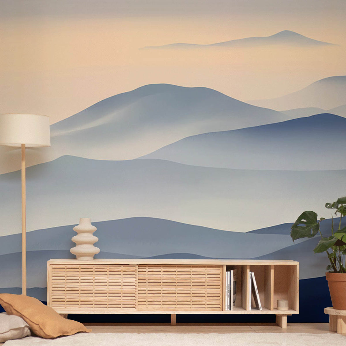 Serene blue mountain wallpaper in living room, featuring light wood furniture and modern decor elements.