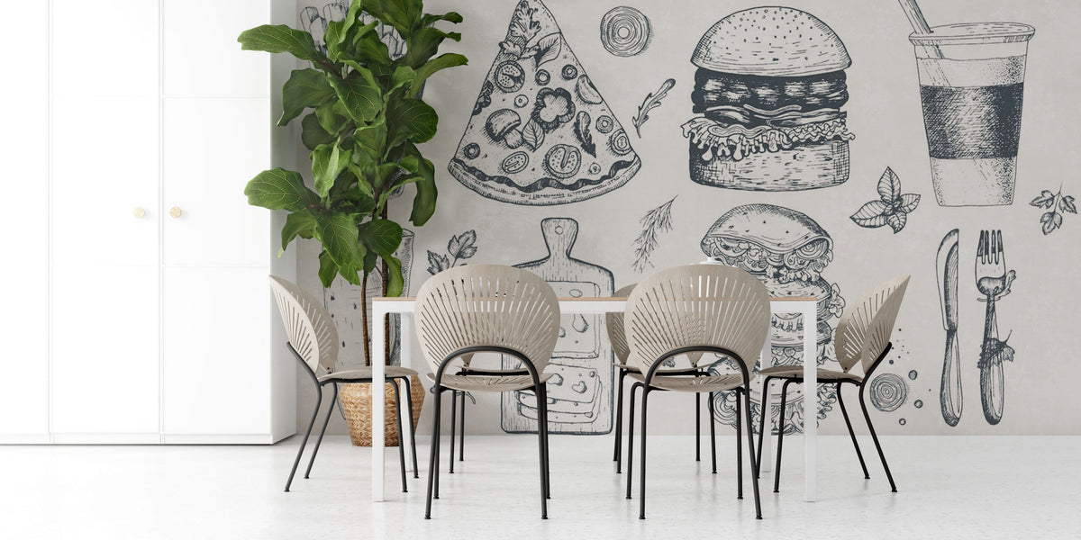 Modern dining room with vintage food sketch mural wallpaper, wooden chairs, white table, and plant decor.