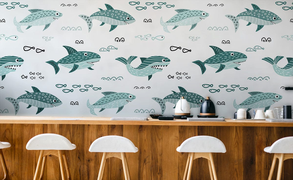 Wallpaper with teal sea creatures, wooden counter, white stools. Whimsical marine pattern enhances decor.