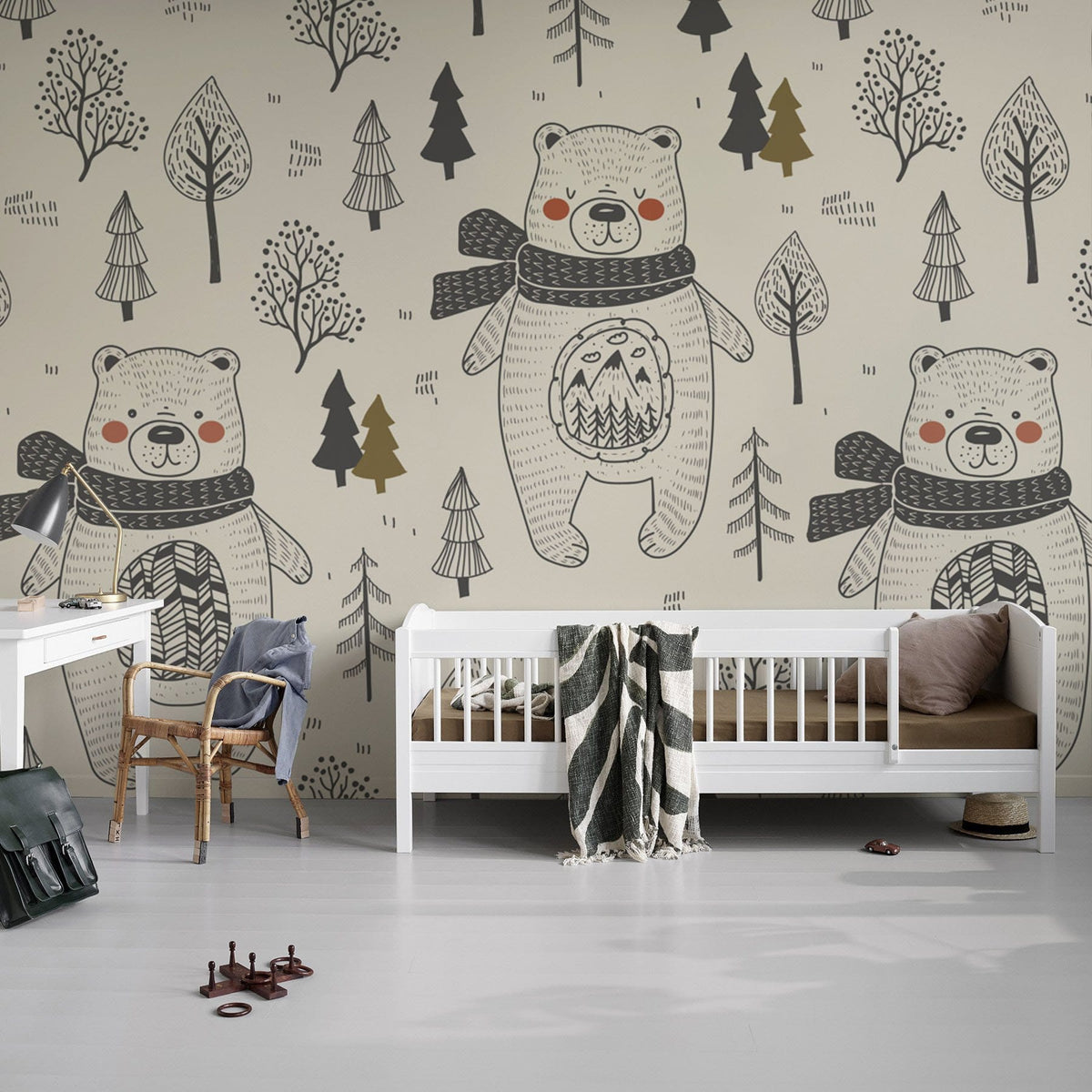 Children's nursery with Whimsical Woodland Bears wallpaper, white furniture, grey flooring, cosy design atmosphere.