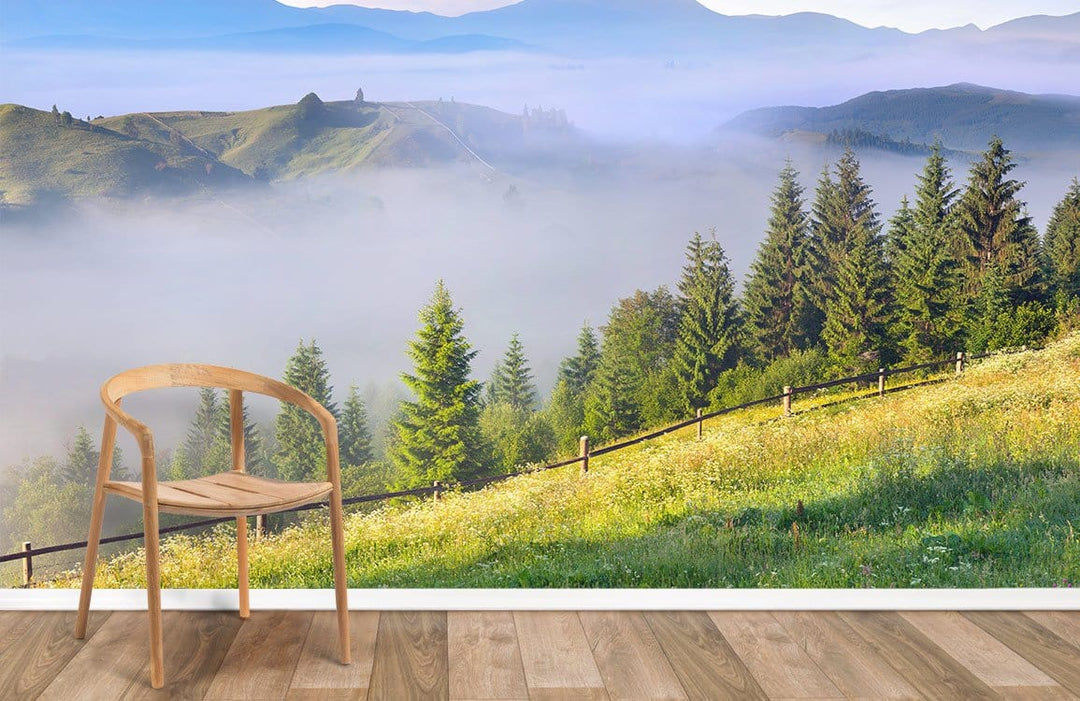 Tranquil Misty Mountain Landscape Mural Wallpaper, wooden chair, wooden flooring, serene green decor.