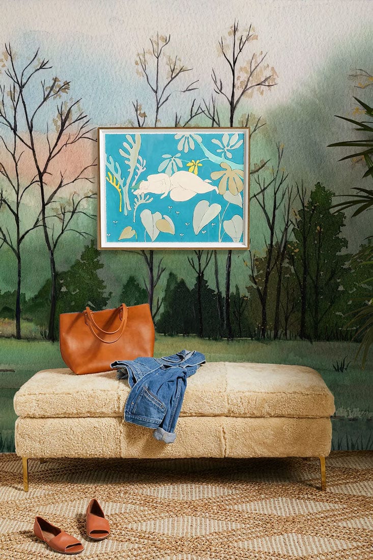 Tranquil woodland watercolour mural wallpaper with beige sofa and woven rug, bright painting in room.