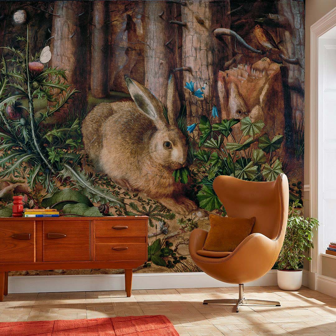 Rabbit mural wallpaper with greenery, mid-century sideboard, tan chair, hardwood flooring, cosy living room setting.