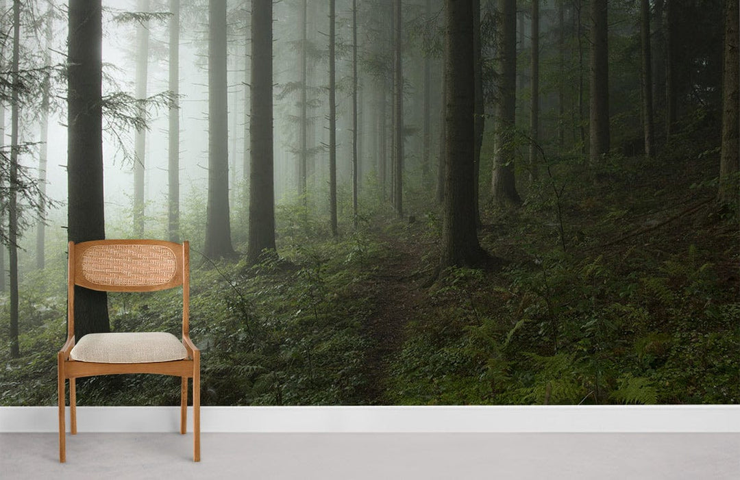 Misty Forest Green Nature Mural Wallpaper with wooden chair on grey flooring in serene interior setting.