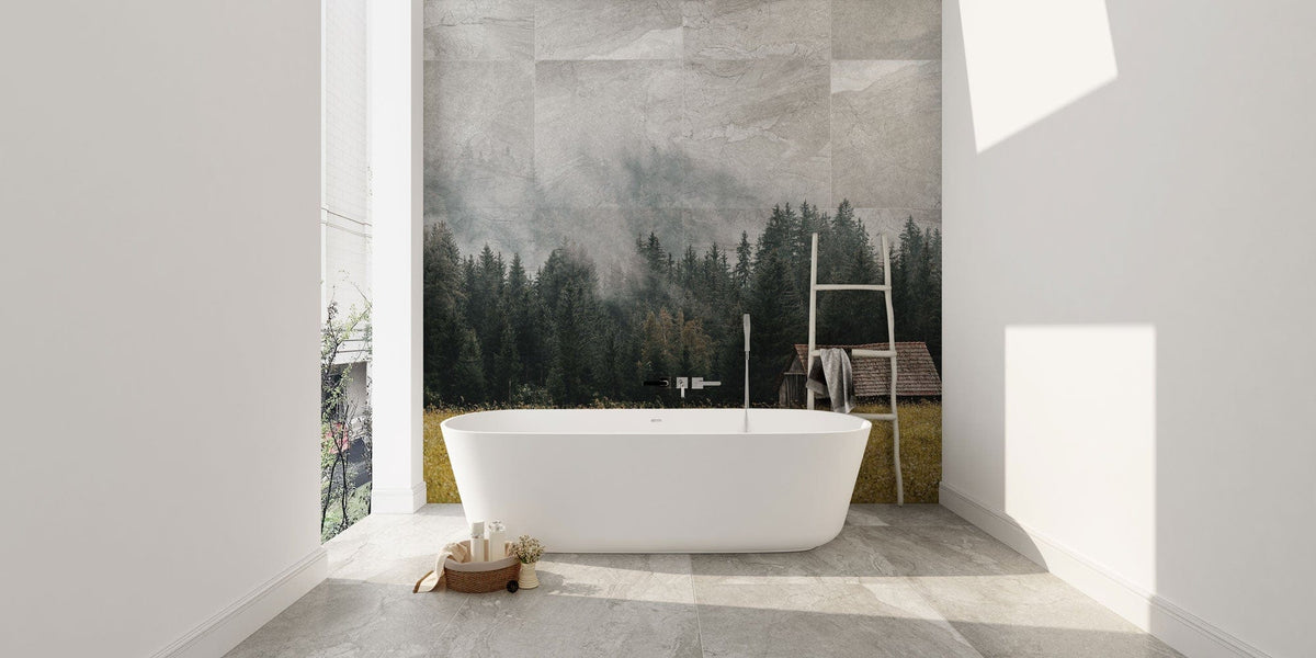 Rustic forest mural wallpaper in bathroom with freestanding tub, ladder-style towel rack, stone flooring.