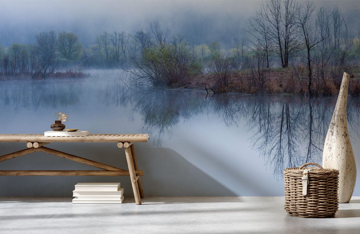 Misty Blue lakeside mural wallpaper with rustic bench in modern room, concrete flooring, wicker basket.