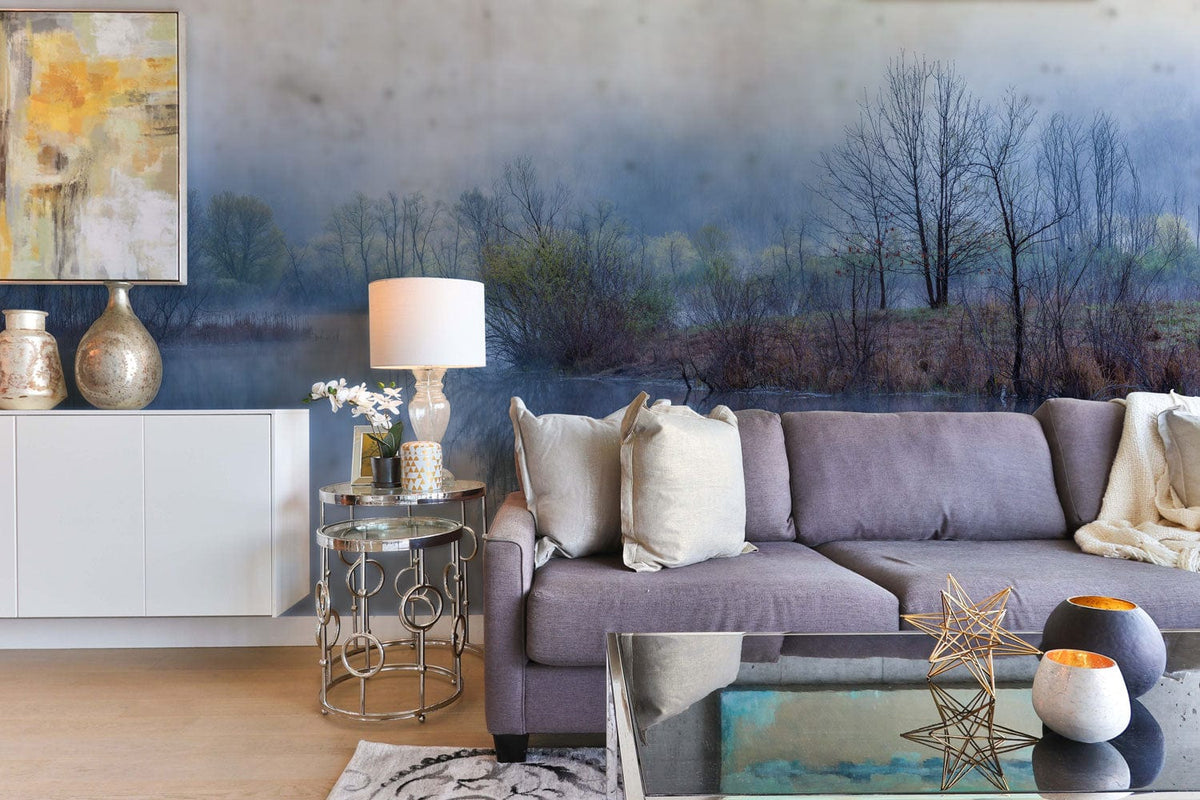 Misty Blue Lakeside Landscape Mural Wallpaper in living room with grey sofa and abstract painting.