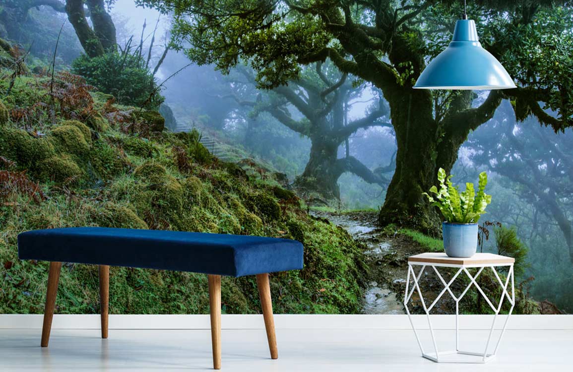 Mystical Forest Green Nature Mural Wallpaper with blue bench, white flooring, and geometric side table.