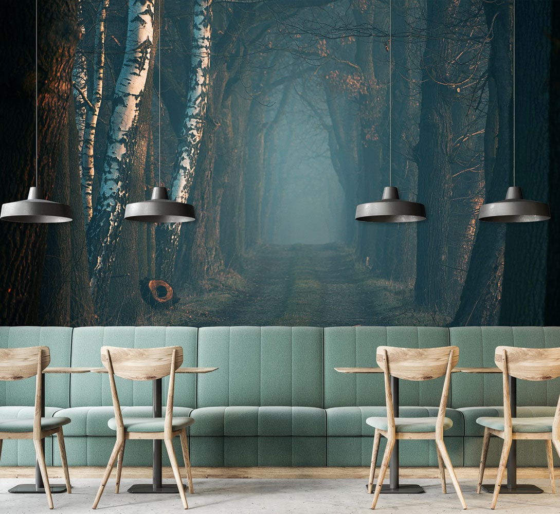 Misty Forest Path Mural adds ambiance in dining room; features green sofa and wood chairs.