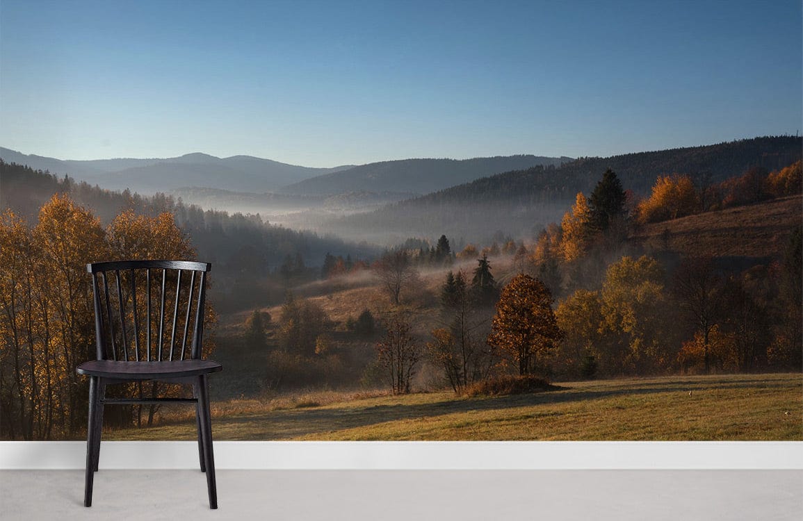 Autumn Misty Valley Landscape Mural Wallpaper with black chair, grey flooring, nature-themed decor in lounge.