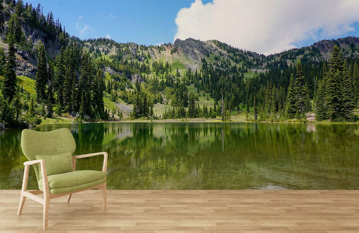 Tranquil Mountain Lake Scene Mural Wallpaper, green chair, wood flooring, serene nature room decor.