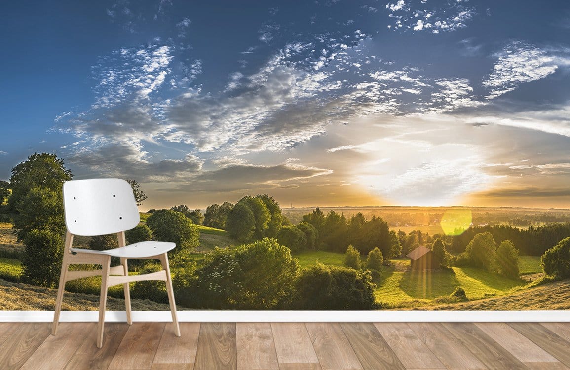 Tranquil Golden Sunrise Landscape Mural with wooden flooring and white minimalist chair in living room.