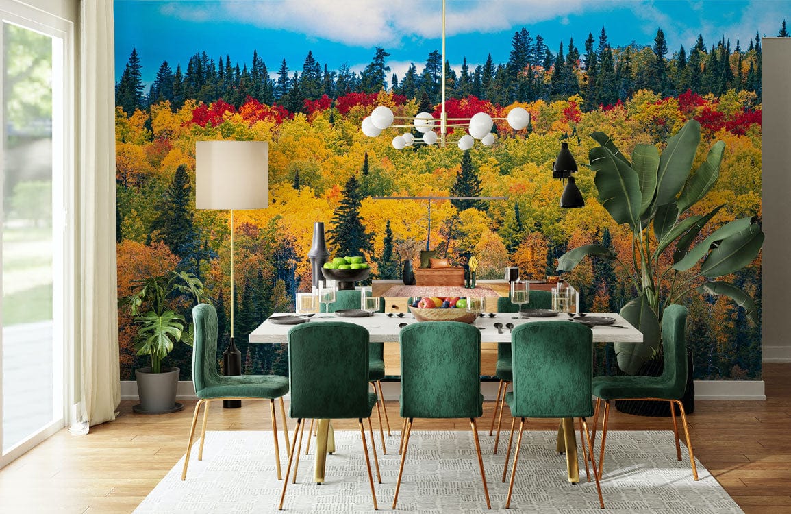 Dining room with vibrant forest mural wallpaper, green velvet chairs, modern chandelier, hardwood flooring.