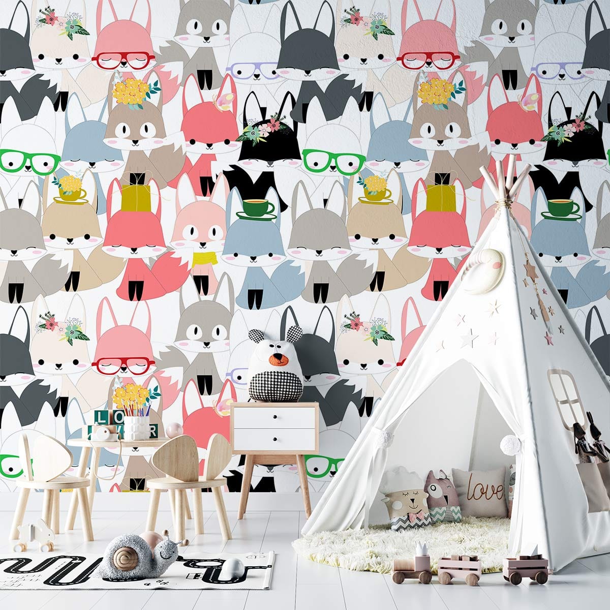 Children's room with whimsical fox wallpaper, white teepee, and wooden furniture; charming woodland theme.