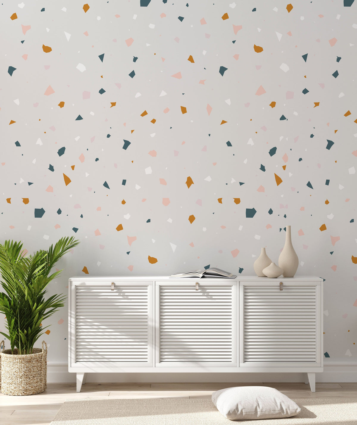 Speckled Terrazzo wallpaper in beige and ochre, white cabinet, indoor plant, modern room design.