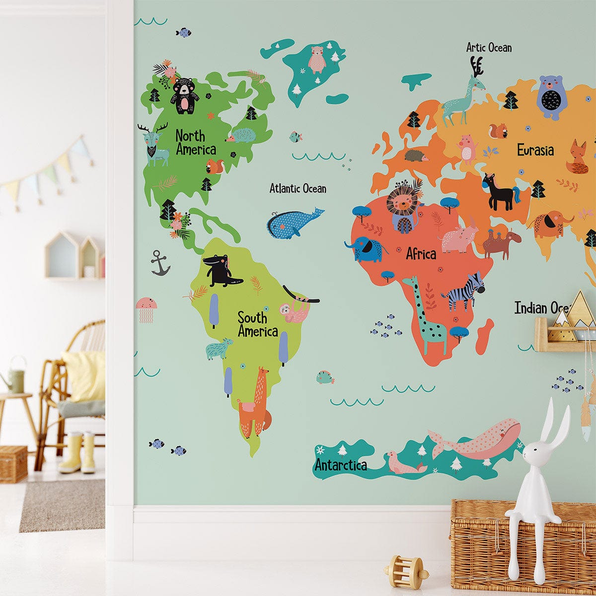 Wall with Colourful Illustrated World Map Kids' Wallpaper, playroom setting, wicker chair, light wood floor.