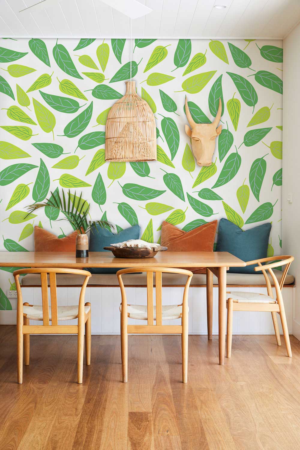 Lively Green Leaf Wallpaper in dining room with wooden chairs, table, and oak flooring for decor.
