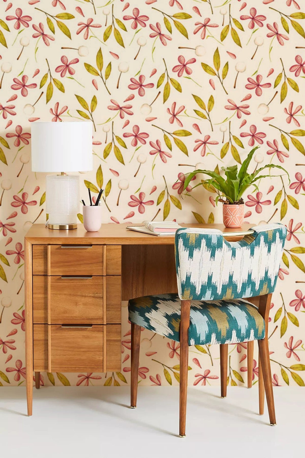 Charming Pink Floral Leaf Wallpaper in room with a wooden desk and patterned chair, elegant decor.