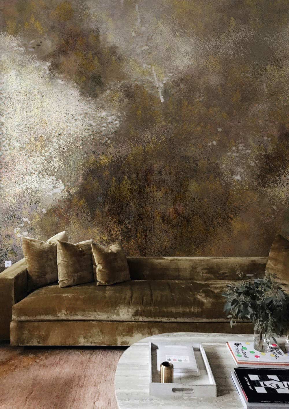 Earthy abstract watercolour mural wallpaper in neutral tones with velvet sofa and wooden flooring.