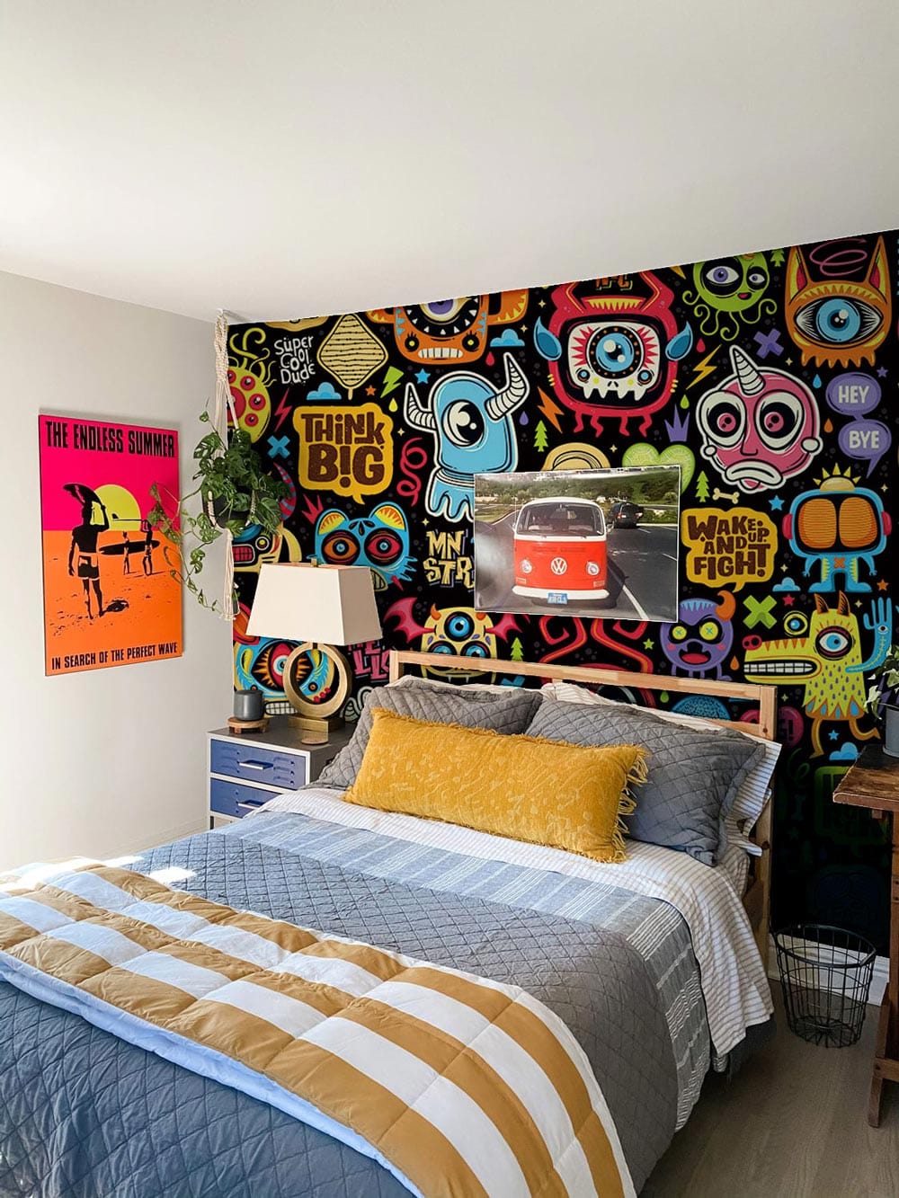 Vibrant Urban Graffiti Cartoon Monster Wallpaper, bed with yellow cushion, modern bedroom decor.