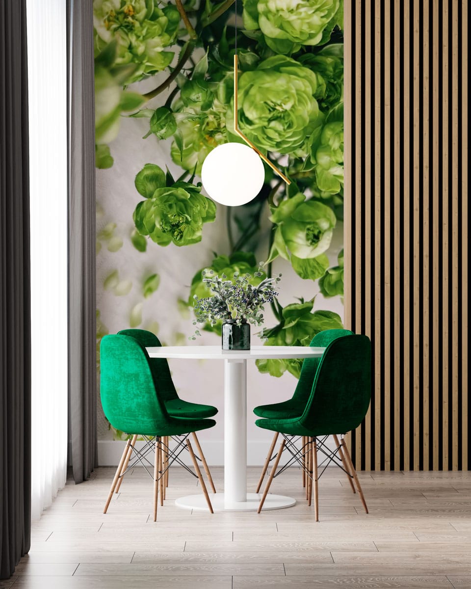 Elegant green floral wallpaper in dining area with green chairs, wooden slats, and pendant light.