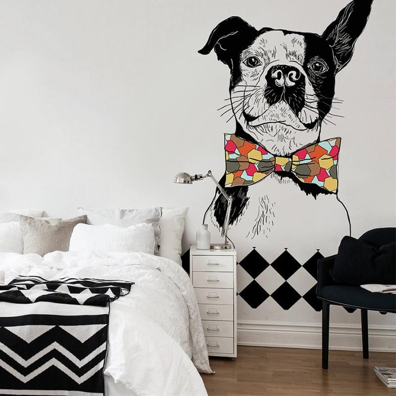 Whimsical mural wallpaper, geometric bow tie, monochrome dog; bedroom with white bed, wooden flooring.