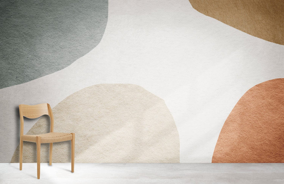 Muted Abstract Shapes Wallpaper in earthy tones, minimalist room, light wood chair, concrete flooring.