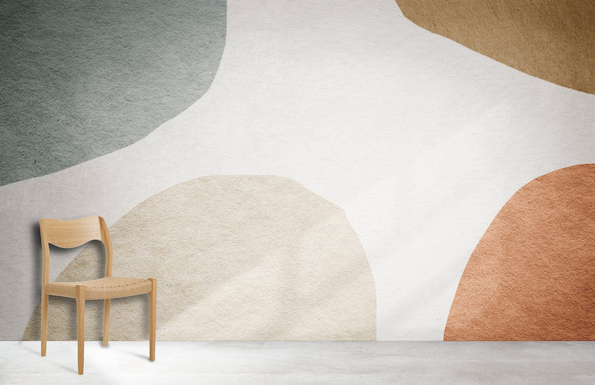 Muted Abstract Shapes Wallpaper in earthy tones, minimalist room, light wood chair, concrete flooring.