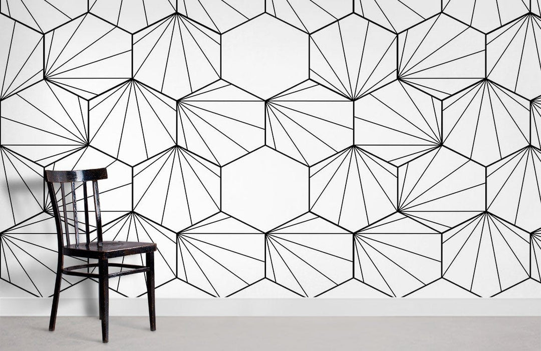 Monochrome geometric hexagon wallpaper featuring modern design, black chair, grey floor, black and white theme.