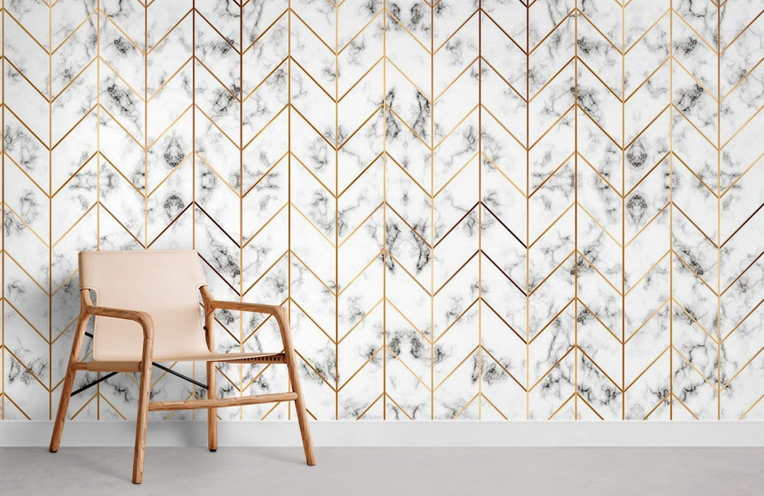 Luxurious white marble chevron wallpaper with gold accents, beige chair, grey flooring in stylish room.