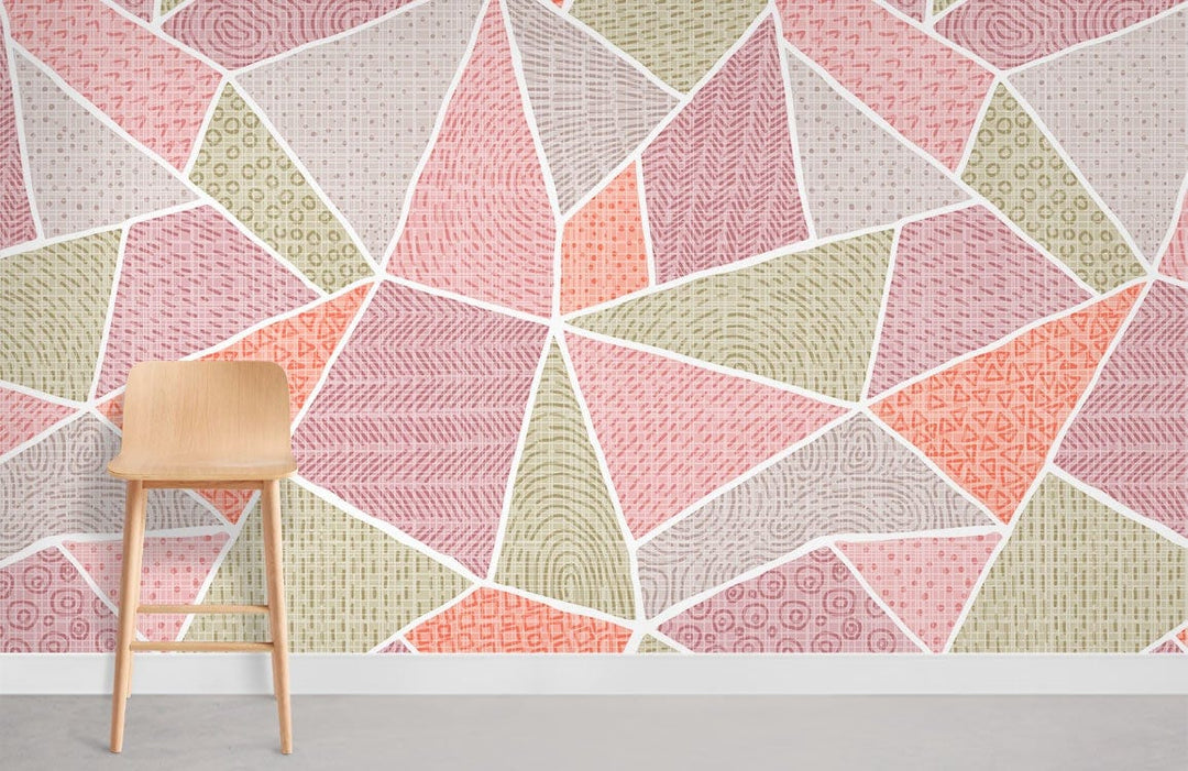 Vintage pastel geo patchwork wallpaper with vibrant pink, green, and orange design, wooden chair, grey flooring.