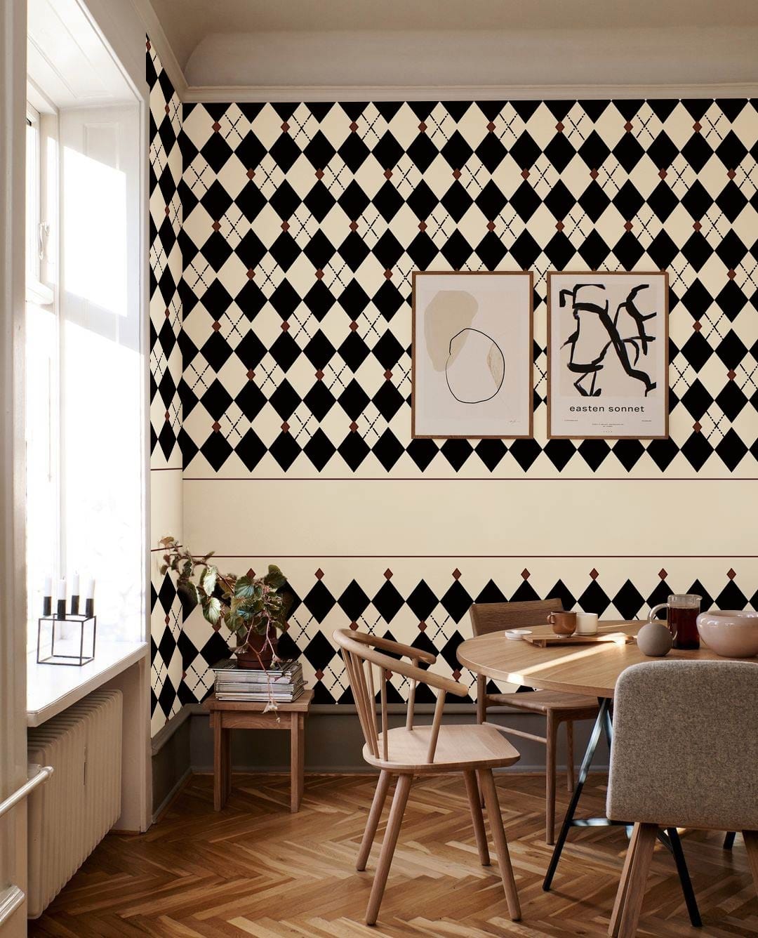 Classic Black and White Harlequin Wallpaper in dining room with wooden flooring, elegant chairs, artwork.