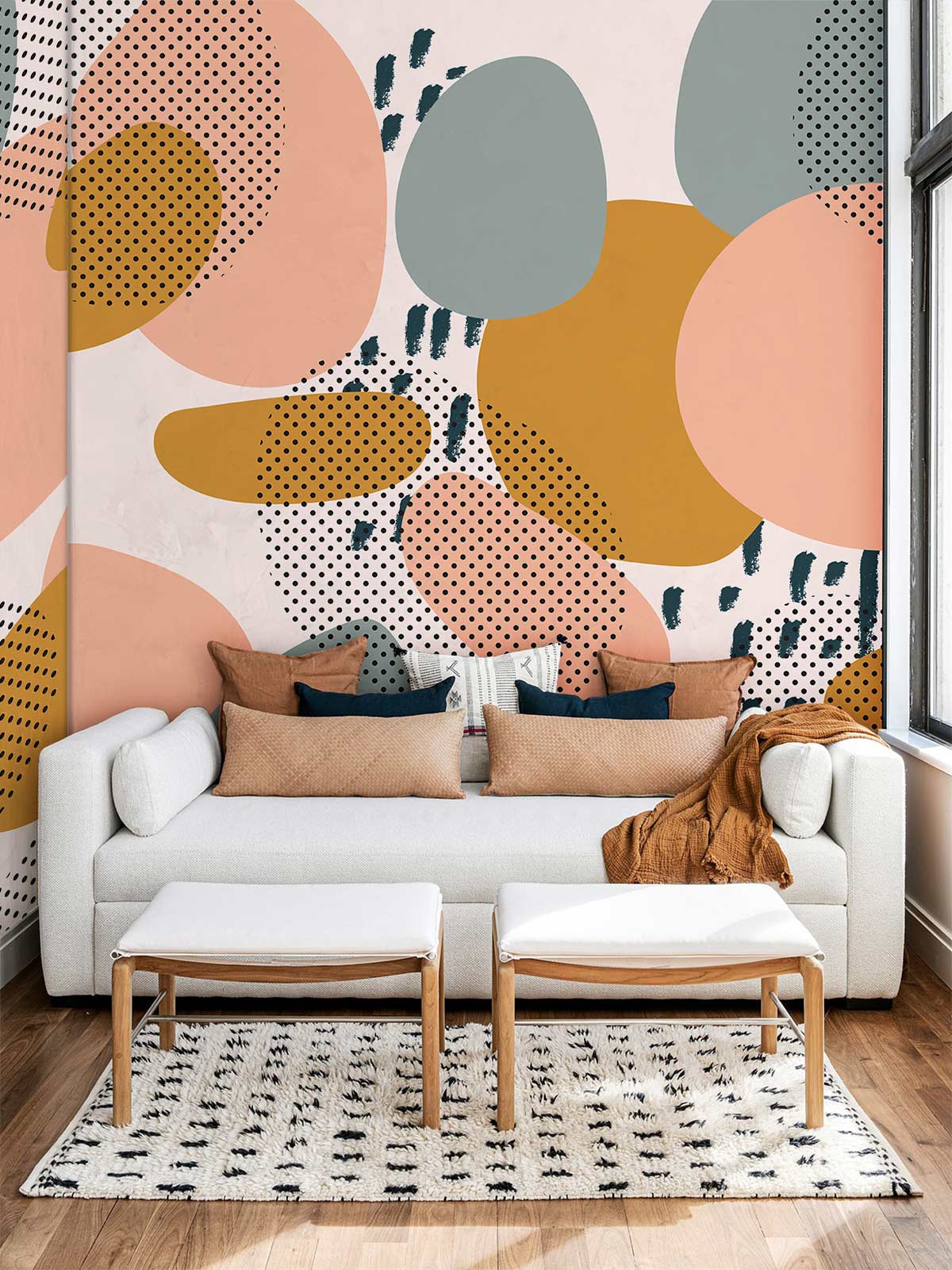 White sofa in living room with Abstract Pastel Geometric Dots Mural Wallpaper, wooden flooring, patterned rug.
