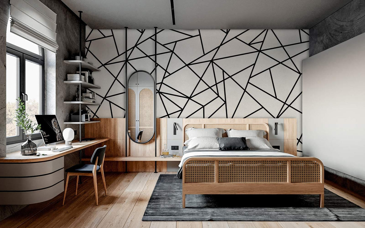 Monochrome geometric wallpaper in modern bedroom with wooden bed, desk, grey rug, and hardwood flooring.