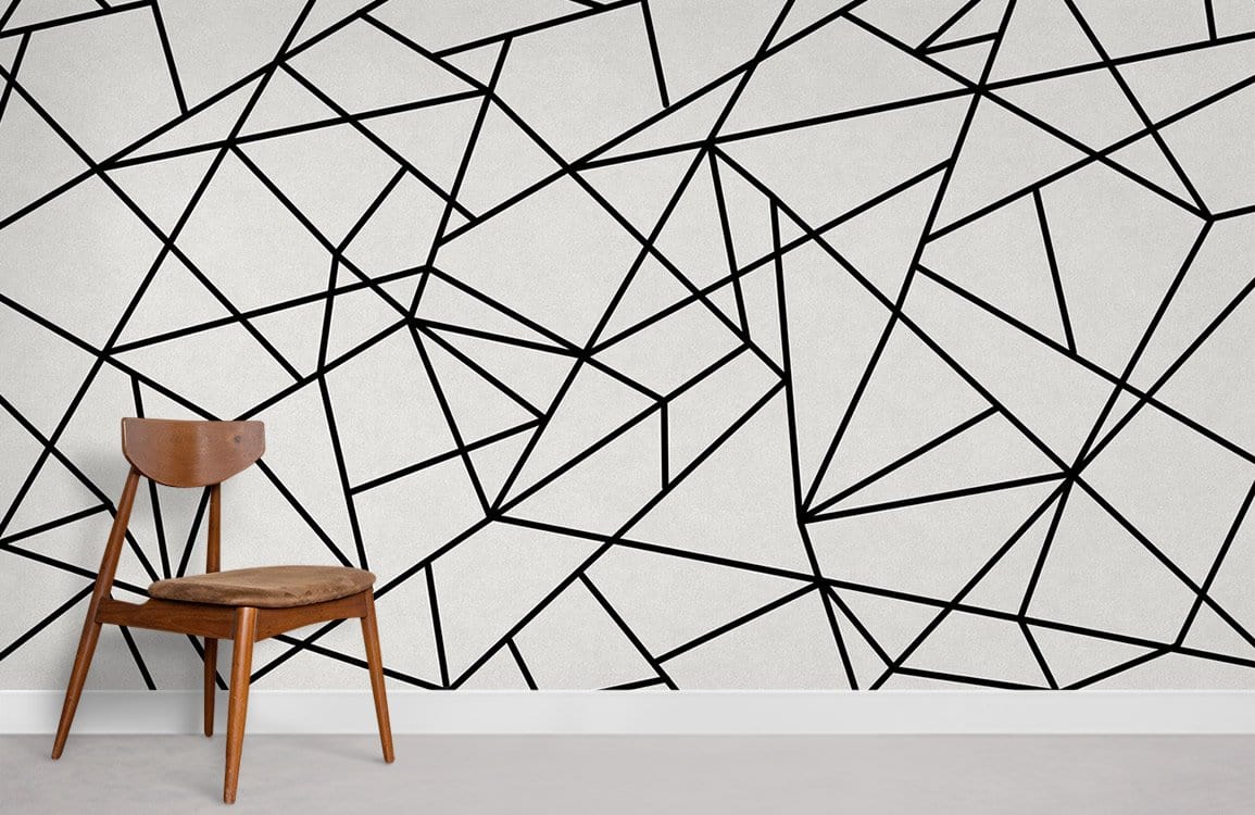 Monochrome geometric lines wallpaper with wooden chair, grey flooring, abstract design, modern room setting.