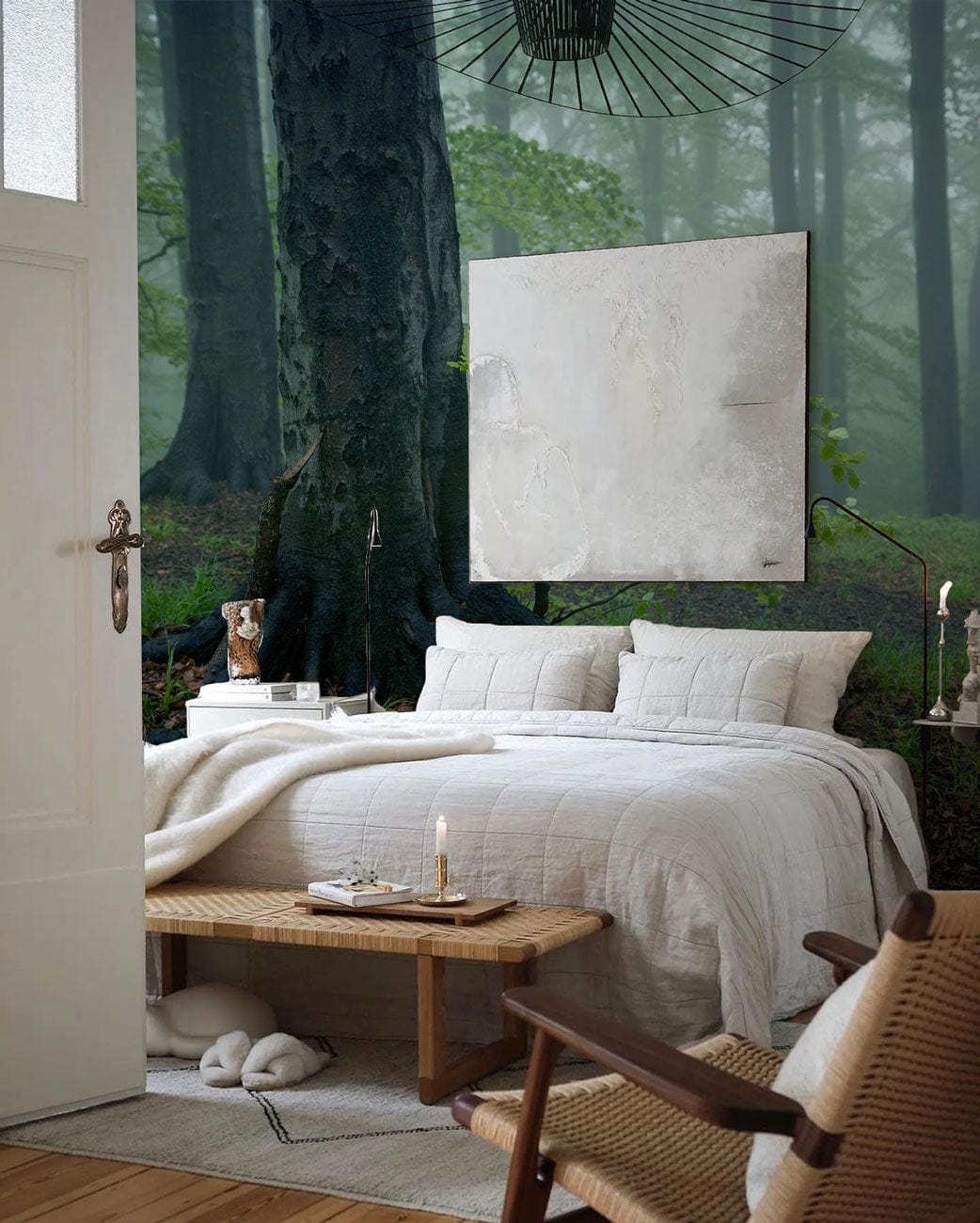 Enchanted Misty Forest Green Landscape Mural Wallpaper in serene bedroom with white bedding, wooden bench.