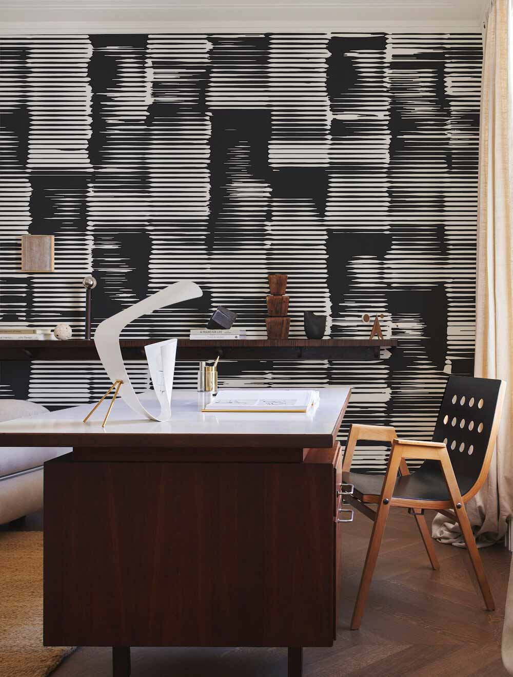Monochrome geometric wallpaper, modern wood desk, black chair, light curtains, elegant contemporary office design.
