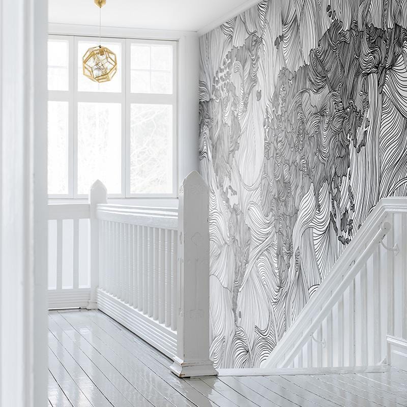 Monochrome World Map mural wallpaper, intricate pattern design, hallway, white staircase, glossy wood flooring.