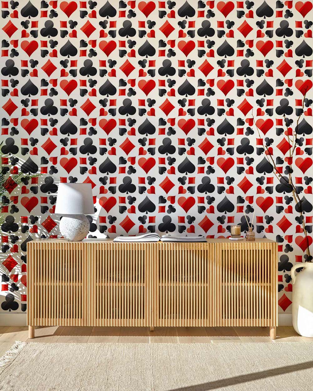 Poker themed red and black card suit wallpaper, natural wood sideboard, and light rug in room.
