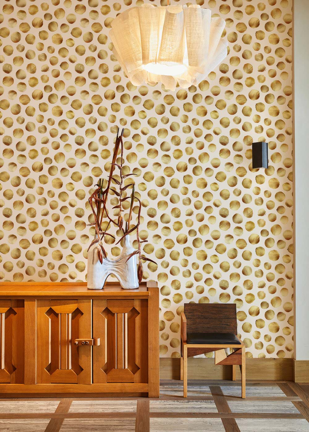 Golden Honeycomb Patterned Wallpaper in modern living room, wooden cabinet, chair, contemporary lighting fixture.