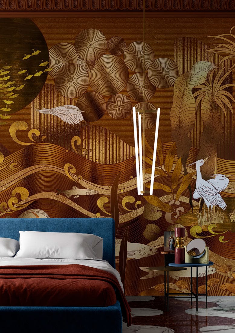 Golden nature textured mural wallpaper features herons, fish, blue velvet bed, and stylish pendant light.