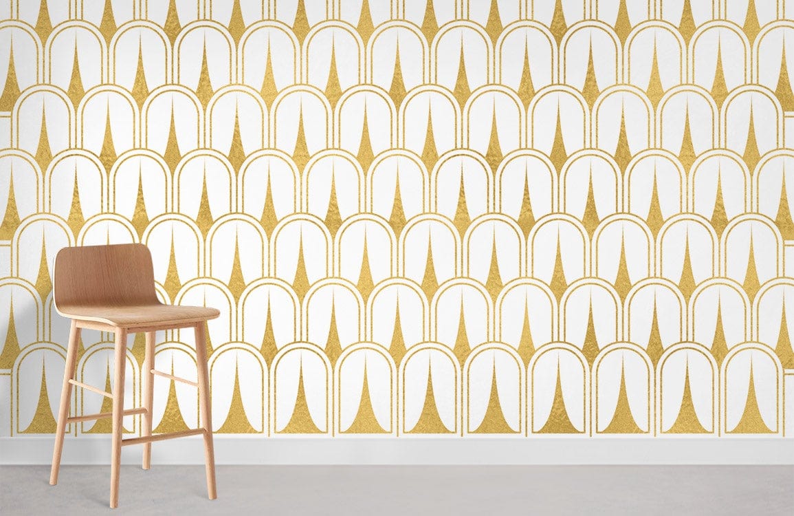 Art Deco gold and white wallpaper with geometric pattern, wooden stool, and grey flooring in modern interior.