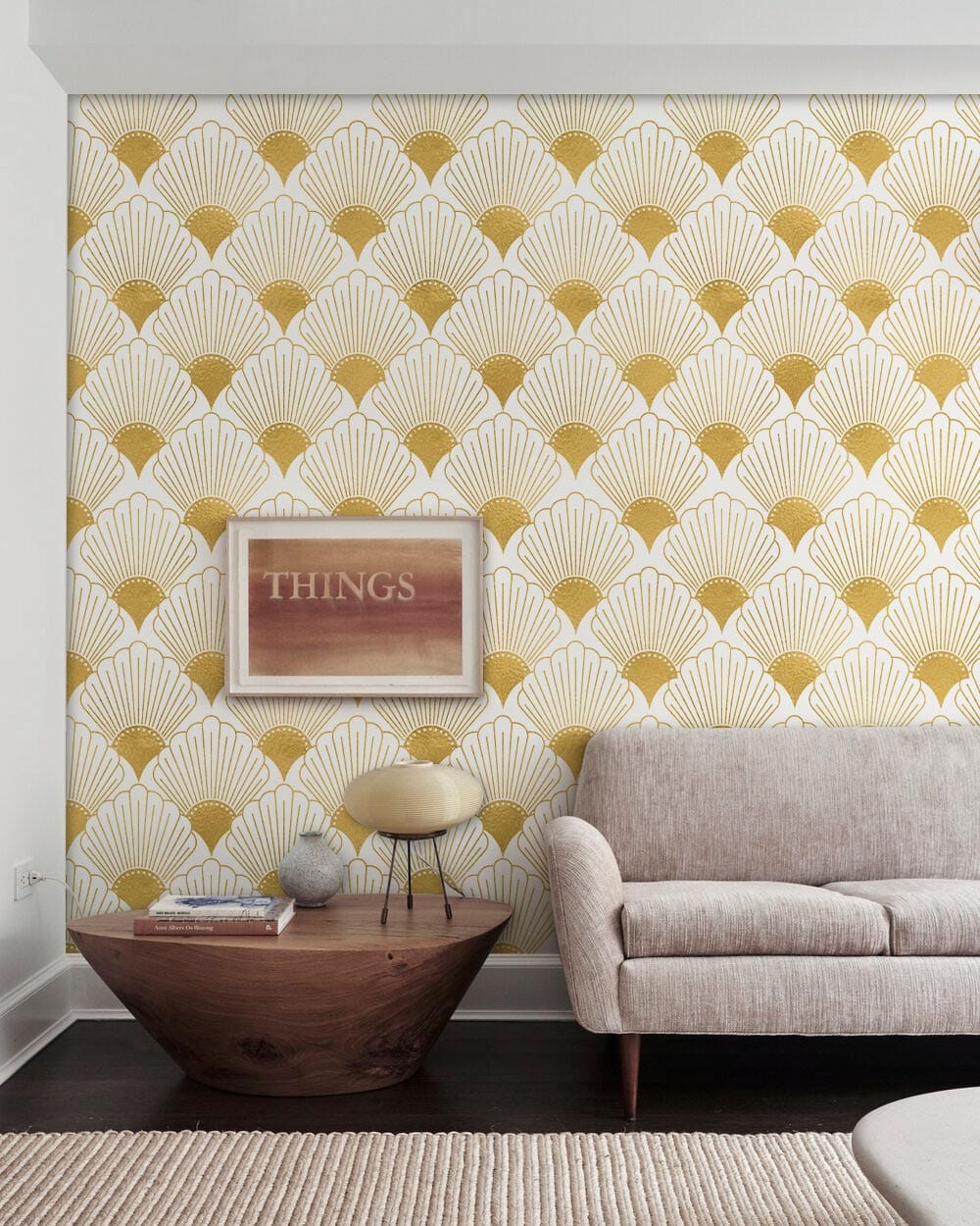 Golden Art Deco wallpaper behind beige sofa, wooden table; elegant vintage geometric room decor.