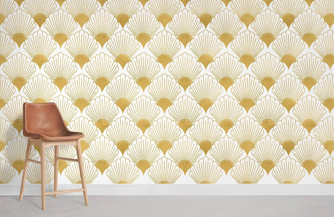 Golden Art Deco fan pattern wallpaper; vintage geometric style decor with modern brown chair, light flooring.