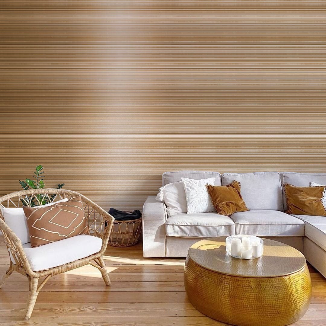 Elegant Metallic Bronze Wallpaper in modern living room with cream sofa, wooden flooring, rattan chair.