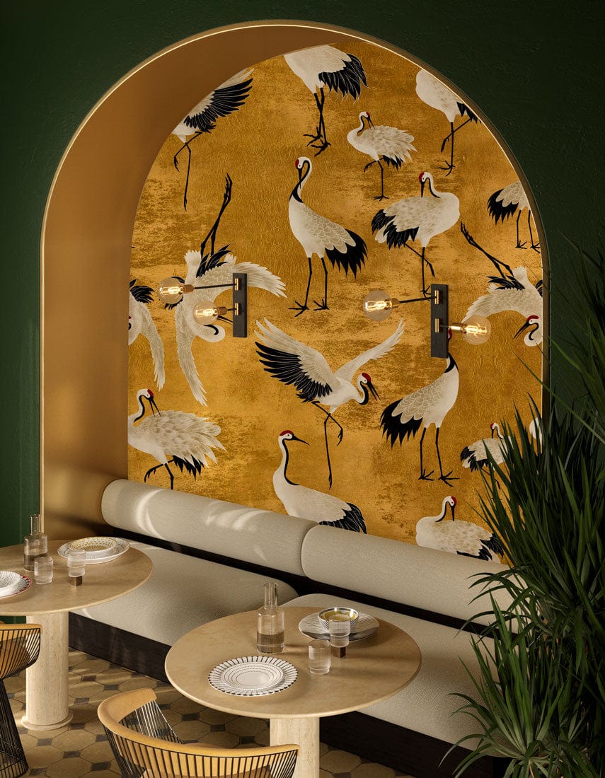 Elegant golden crane wallpaper in dining area with vintage oriental bird pattern and beige seating.
