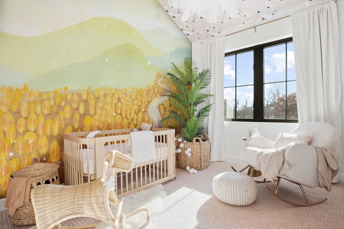 Golden autumn mural wallpaper in nursery, featuring wooden cot, rocking chair, beige flooring, and curtains.